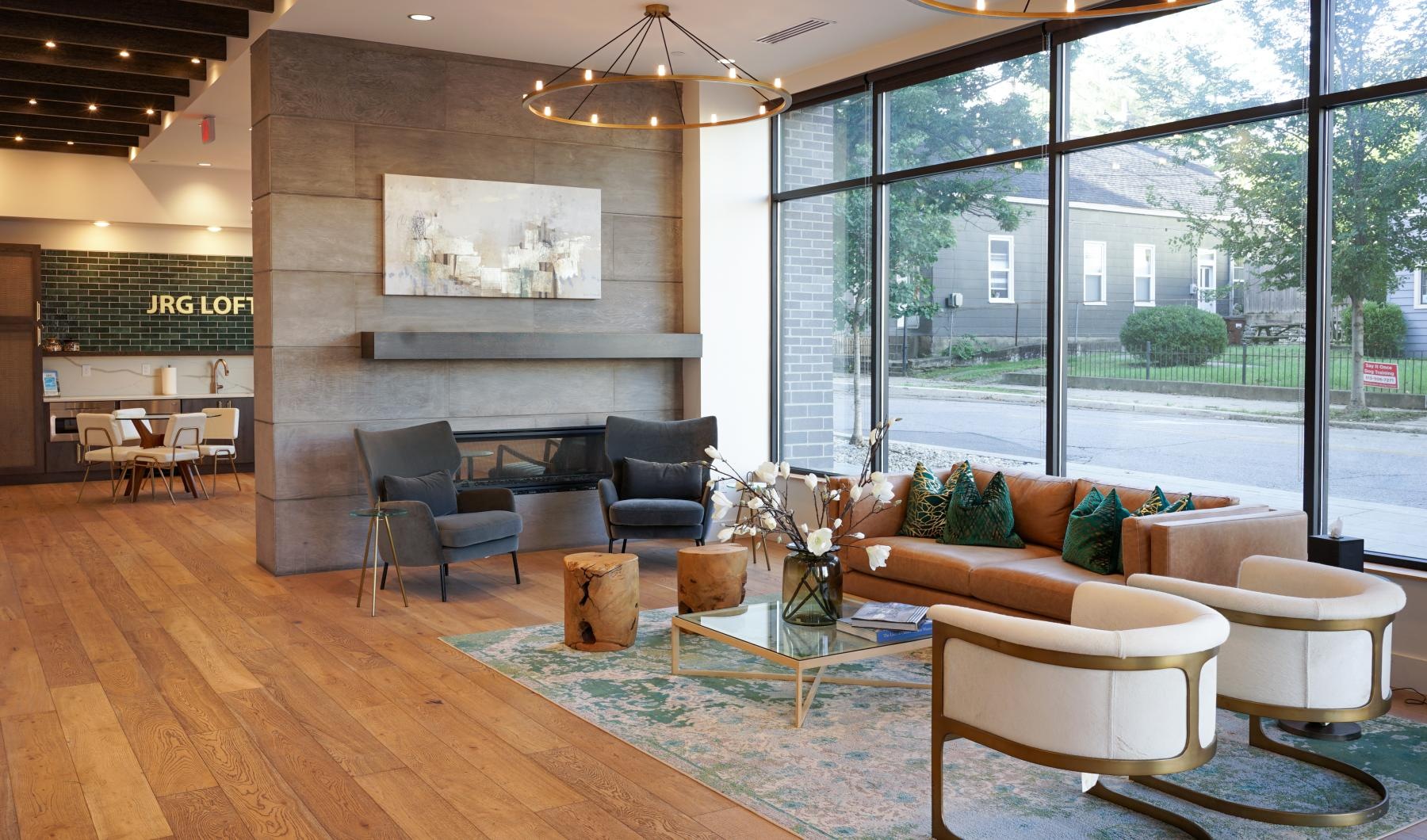 a room with a large glass window and various seating