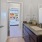 a bathroom with a sink and a bedroom beyond