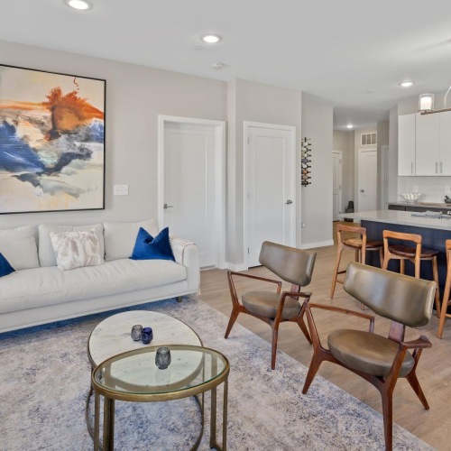 a living room with a couch and chairs