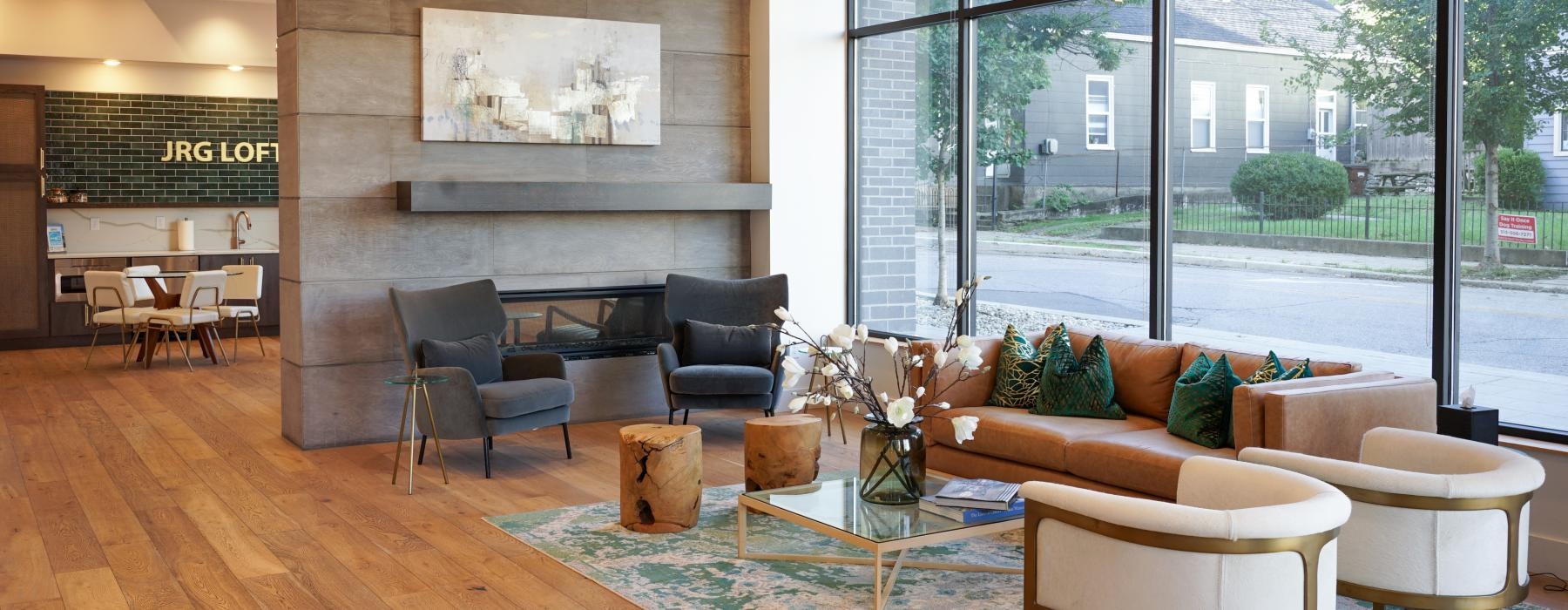a room with a large glass window and various seating