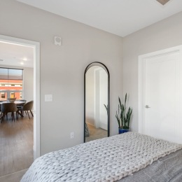 a bedroom with a bed and a mirror