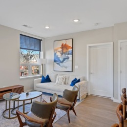 a living room with a couch a table and chairs