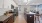 a kitchen with a large island a stovetop and a sink