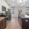a kitchen with a large island a stovetop and a sink