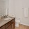 a bathroom with a marble countertop a sink and a toilet