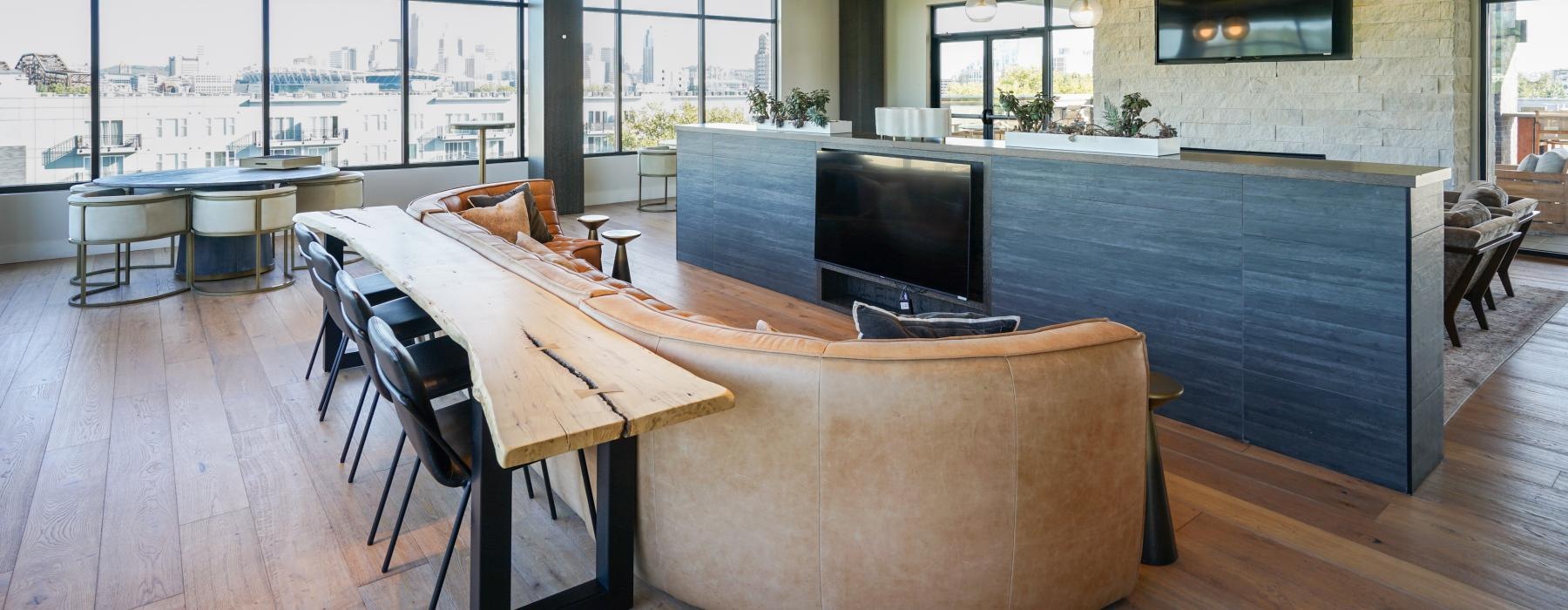a lounge room with a bar and chairs