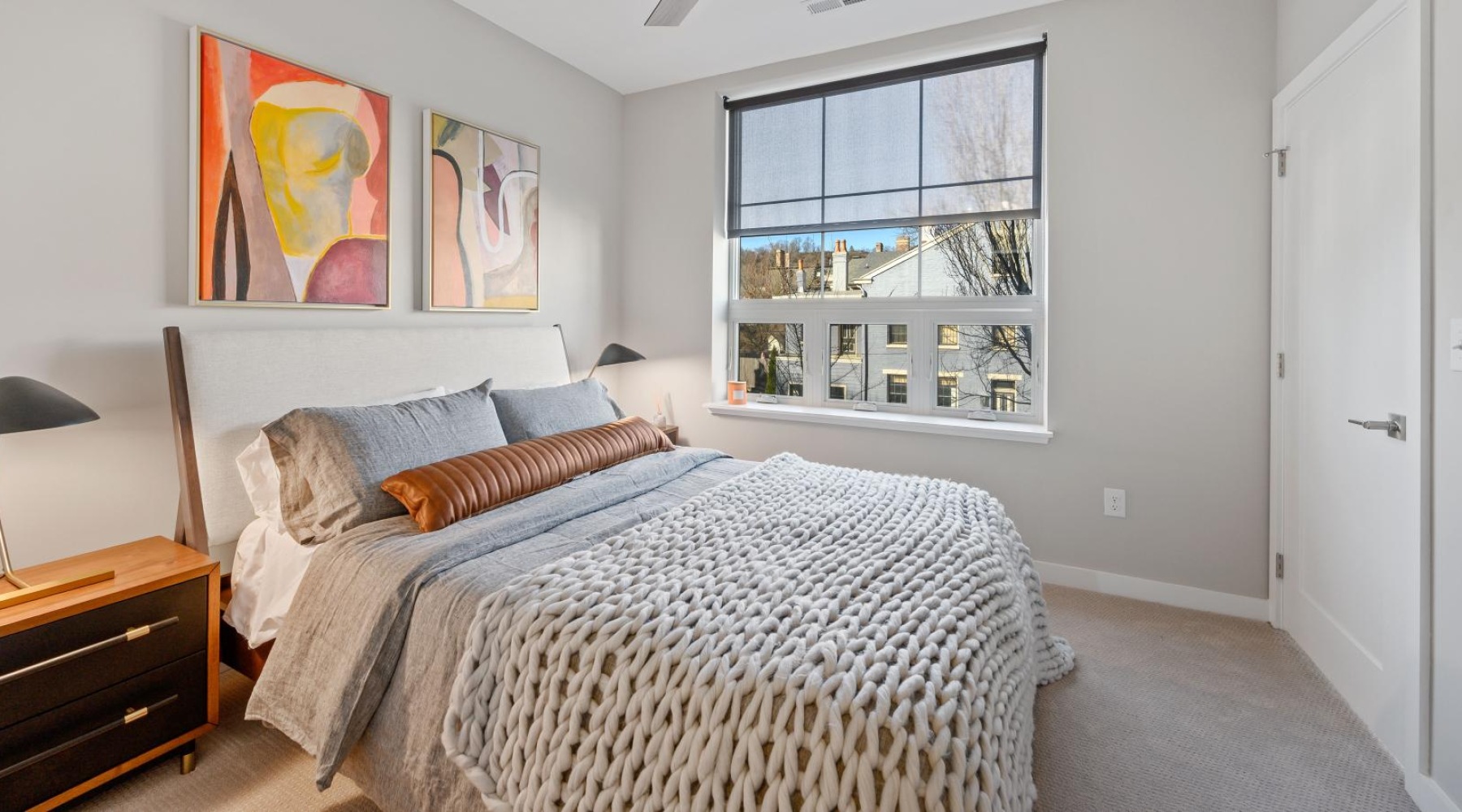 a bedroom with a large window