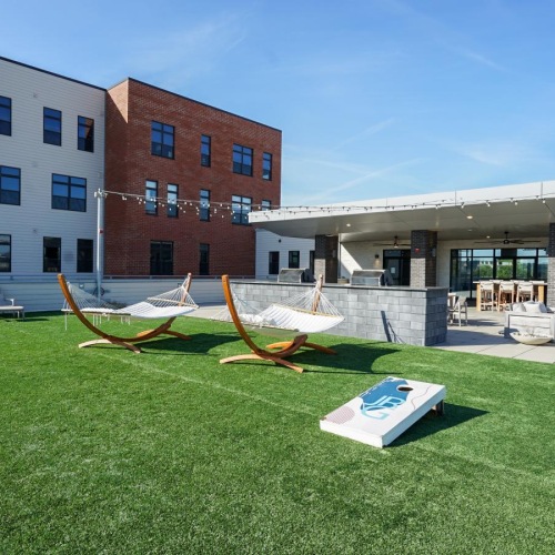 a building with a lawn and chairs