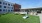 a building with a lawn and chairs