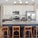 a kitchen with an island bar and stools