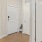an entryway with a bathroom with white doors
