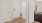 an entryway with a bathroom with white doors